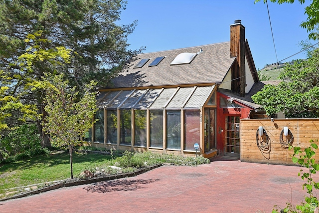 528 N Westcapitol St, Salt Lake City, UT 84103 - view of front of home with roof with shingles, a chimney, an exterior structure, and a front lawn