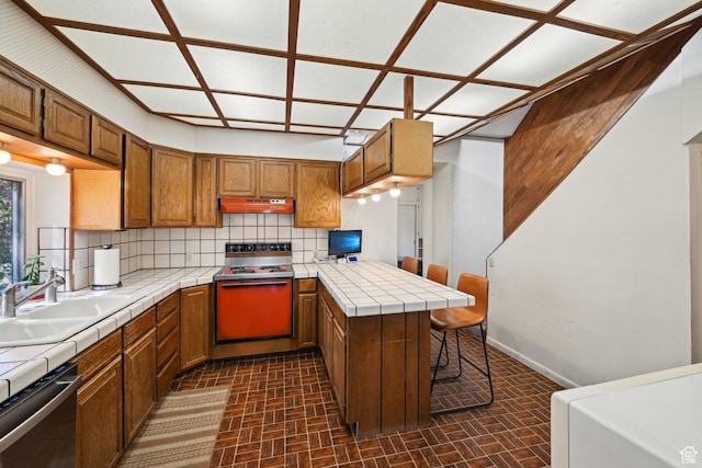 528 N Westcapitol St, Salt Lake City, UT 84103 - kitchen with tile countertops, stainless steel dishwasher, electric range oven, a peninsula, and under cabinet range hood