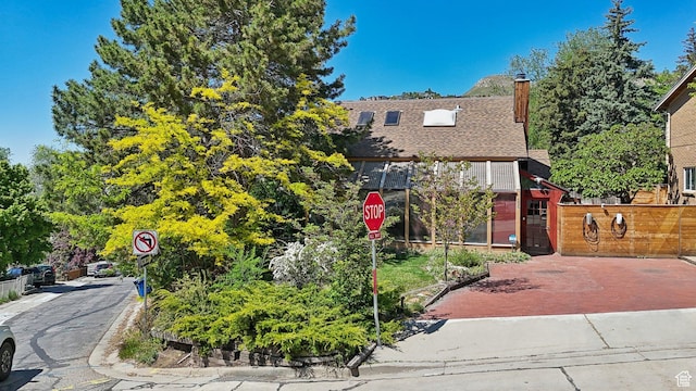 528 N Westcapitol St, Salt Lake City, UT 84103 - view of front facade featuring a shingled roof, a chimney, and fence