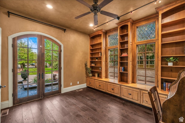 interior space featuring french doors, baseboards, dark wood finished floors, ceiling fan, and built in features