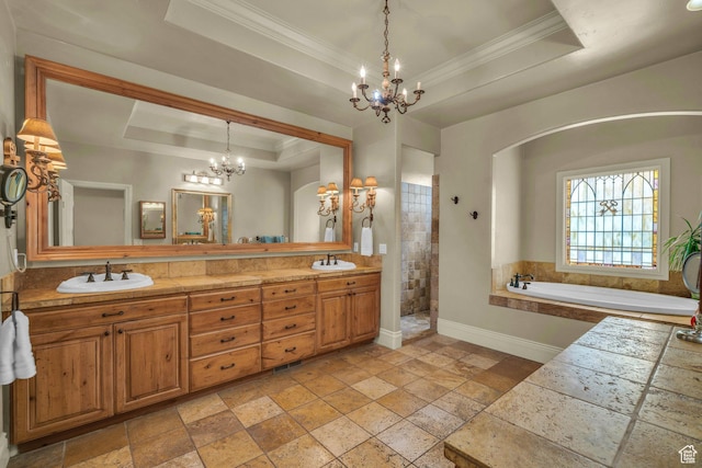 bathroom featuring a raised ceiling, a chandelier, stone tile flooring, baseboards, and crown molding