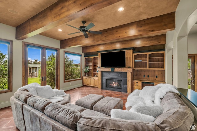 living area featuring light tile patterned flooring, baseboards, recessed lighting, a fireplace, and beamed ceiling