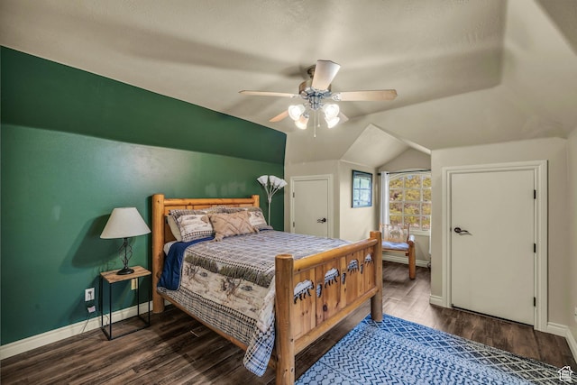 bedroom with baseboards, wood finished floors, lofted ceiling, and ceiling fan