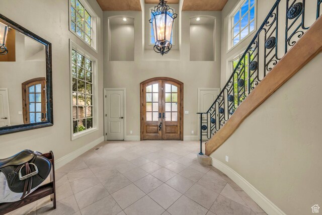 3770 Sugar Leo Rd, Bloomington, UT 84790 - tiled entrance foyer featuring a chandelier, french doors, a towering ceiling, and stairway