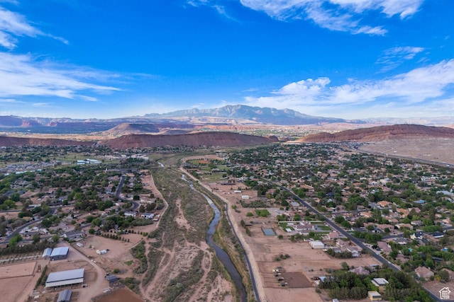 aerial view of property and surrounding area featuring a mountain backdrop