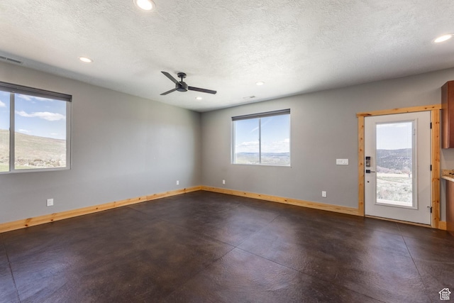 420 E Rockport Aspen Dr, Coalville, UT 84017 - empty room with baseboards, recessed lighting, a textured ceiling, a ceiling fan, and finished concrete floors