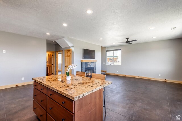 420 E Rockport Aspen Dr, Coalville, UT 84017 - kitchen featuring baseboards, a fireplace, a kitchen island, recessed lighting, and ceiling fan