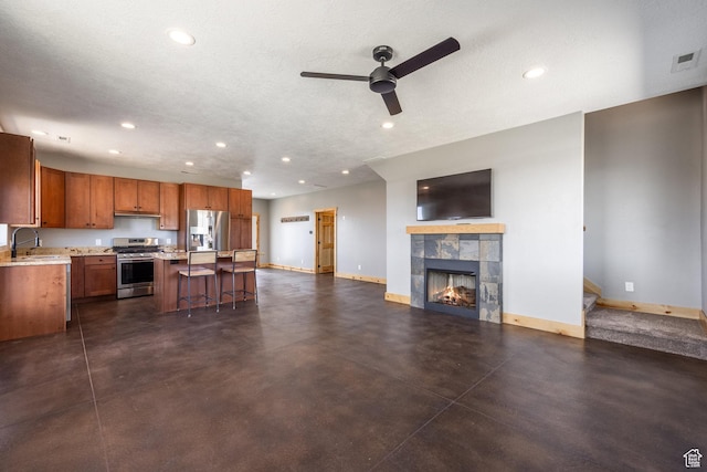 420 E Rockport Aspen Dr, Coalville, UT 84017 - kitchen with appliances with stainless steel finishes, baseboards, a sink, light countertops, and ceiling fan