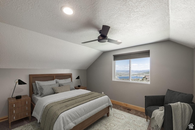 420 E Rockport Aspen Dr, Coalville, UT 84017 - carpeted bedroom with vaulted ceiling, baseboards, a textured ceiling, a ceiling fan, and a water view
