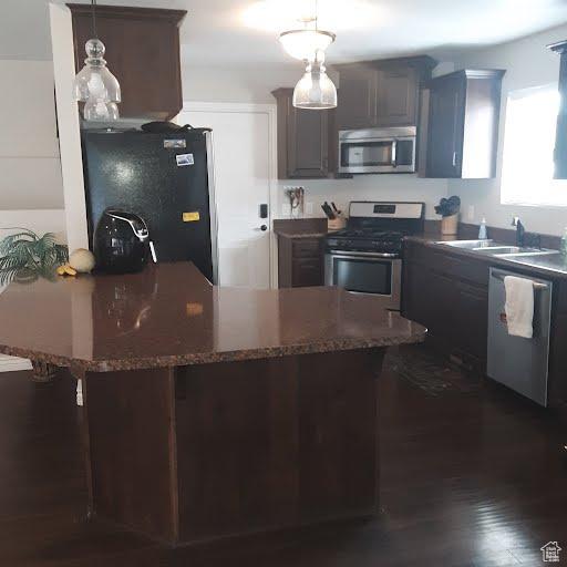 42 E 780 S, Ephraim, UT 84627 - kitchen with stainless steel appliances, a sink, hanging light fixtures, dark stone counters, and a breakfast bar