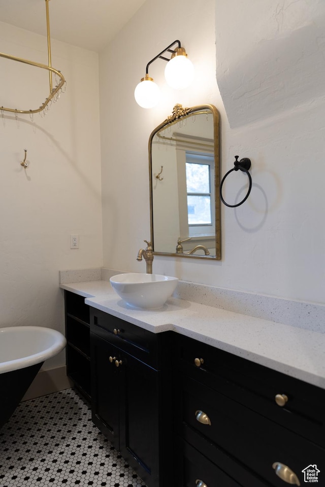 bathroom featuring vanity and a freestanding bath