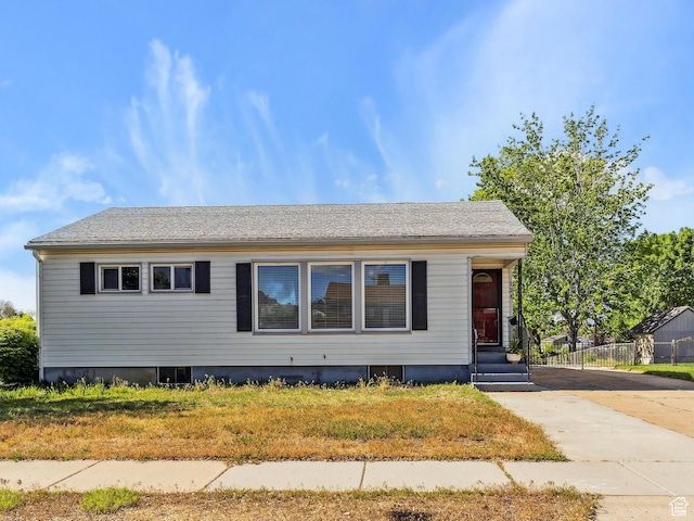 view of front facade featuring fence and concrete driveway