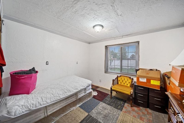 bedroom with crown molding and a textured ceiling