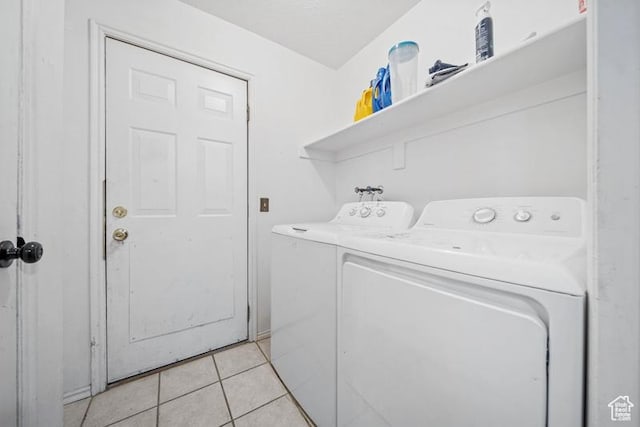 laundry area featuring independent washer and dryer and light tile patterned flooring