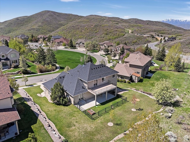 aerial overview of property's location featuring nearby suburban area and a mountain backdrop