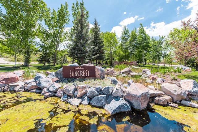 community sign featuring a garden pond