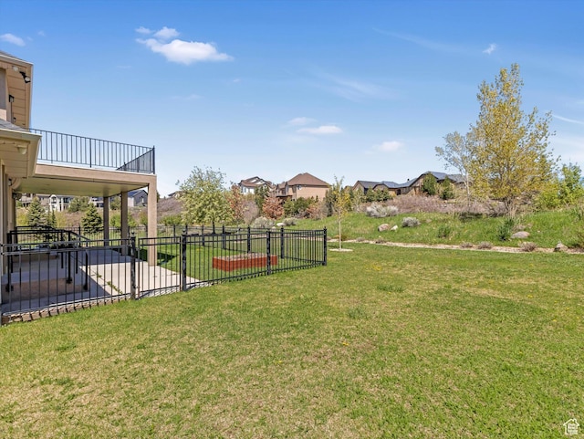 view of yard with a balcony and a patio