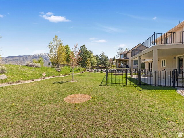 view of yard featuring a balcony and a patio