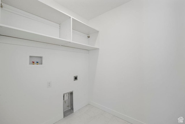 laundry room featuring hookup for a washing machine, light marble finish flooring, hookup for an electric dryer, and baseboards