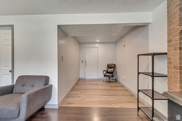 living area featuring wood finished floors and baseboards