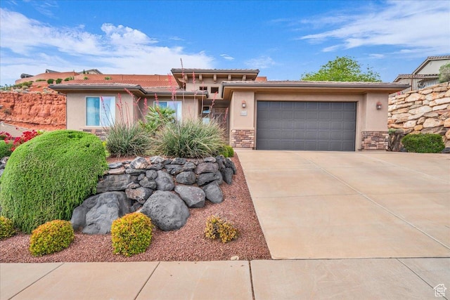 1668 W Lakota Dr, St George, UT 84770 - view of front of property featuring stone siding, stucco siding, driveway, and a garage