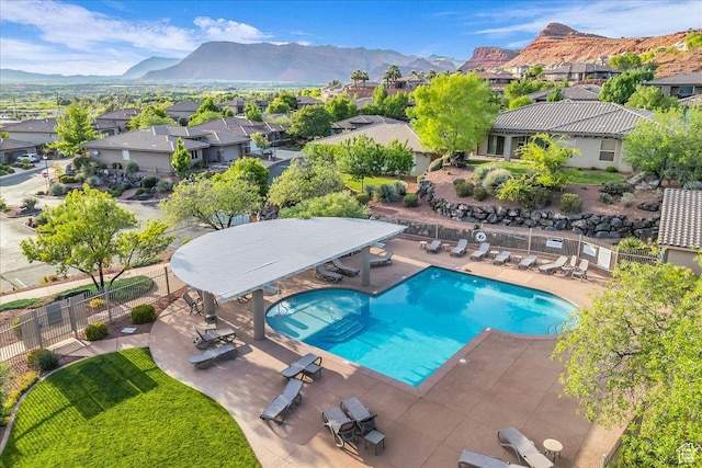 1668 W Lakota Dr, St George, UT 84770 - community pool with a residential view, a mountain view, a patio area, and fence