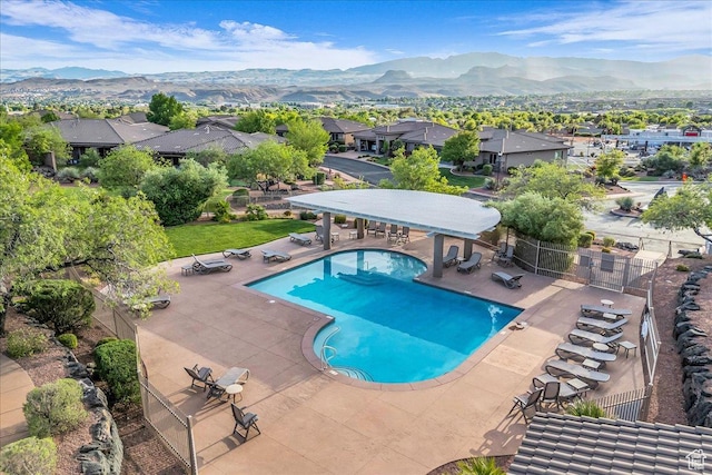 1668 W Lakota Dr, St George, UT 84770 - community pool featuring fence, a patio, a mountain view, and a residential view