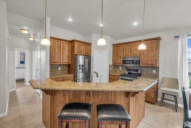 1668 W Lakota Dr, St George, UT 84770 - kitchen with stainless steel appliances, baseboards, brown cabinetry, and light tile patterned floors