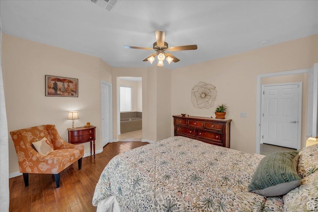 1668 W Lakota Dr, St George, UT 84770 - bedroom featuring hardwood / wood-style flooring, baseboards, ceiling fan, and ensuite bath