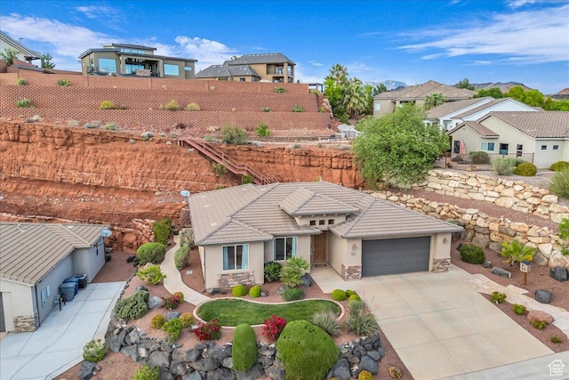 1668 W Lakota Dr, St George, UT 84770 - view of front of house featuring stucco siding, fence, a garage, and driveway