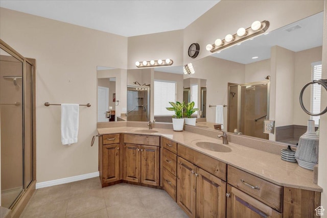 1668 W Lakota Dr, St George, UT 84770 - bathroom with a shower stall, tile patterned floors, baseboards, and double vanity