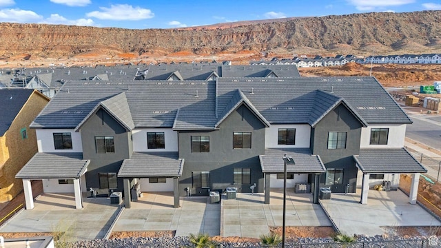 1674 S Ripple Rock Dr Unit 3178, Washington, UT 84780 - view of front of home with a mountain view, stucco siding, outdoor lounge area, a patio, and a residential view
