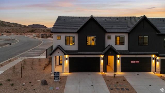 1674 S Ripple Rock Dr Unit 3178, Washington, UT 84780 - view of front facade with an attached garage, stucco siding, concrete driveway, and a mountain view