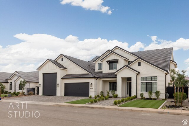 3855 S Kennedy Ln, Washington, UT 84780 - modern farmhouse style home featuring a garage, decorative driveway, board and batten siding, and fence