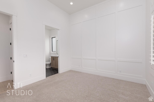 3855 S Kennedy Ln, Washington, UT 84780 - unfurnished bedroom with carpet, a decorative wall, ensuite bathroom, and recessed lighting