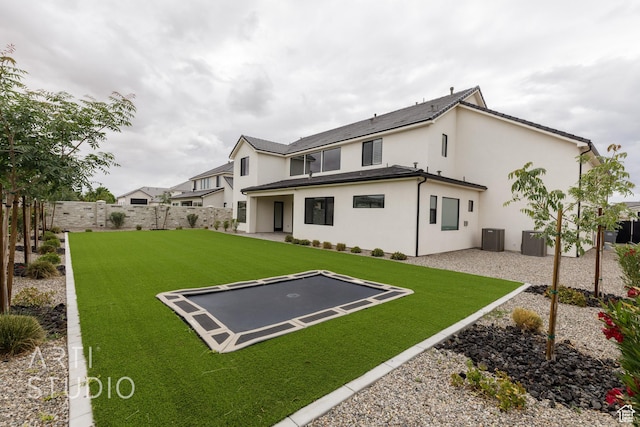 3855 S Kennedy Ln, Washington, UT 84780 - rear view of property with a trampoline, stucco siding, a patio area, and cooling unit
