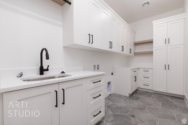 3855 S Kennedy Ln, Washington, UT 84780 - clothes washing area with cabinet space, electric dryer hookup, and hookup for a washing machine