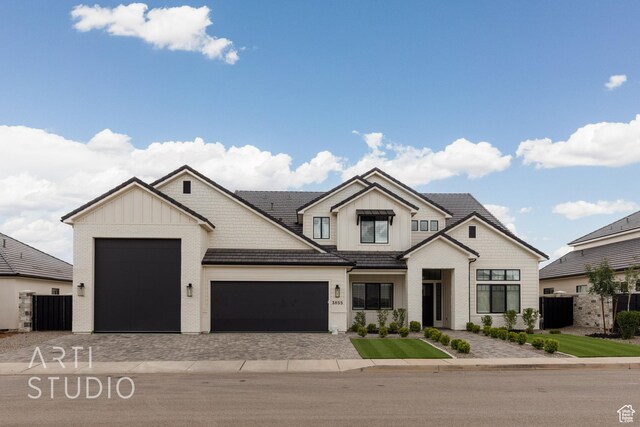 3855 S Kennedy Ln, Washington, UT 84780 - modern farmhouse style home featuring a garage, decorative driveway, board and batten siding, and fence