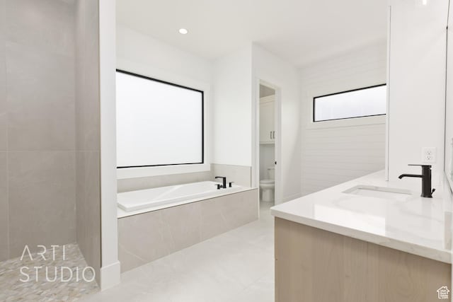 3855 S Kennedy Ln, Washington, UT 84780 - bathroom featuring toilet, a garden tub, double vanity, and tile patterned floors