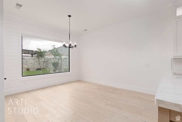 3855 S Kennedy Ln, Washington, UT 84780 - unfurnished dining area with light wood-type flooring, a chandelier, and baseboards