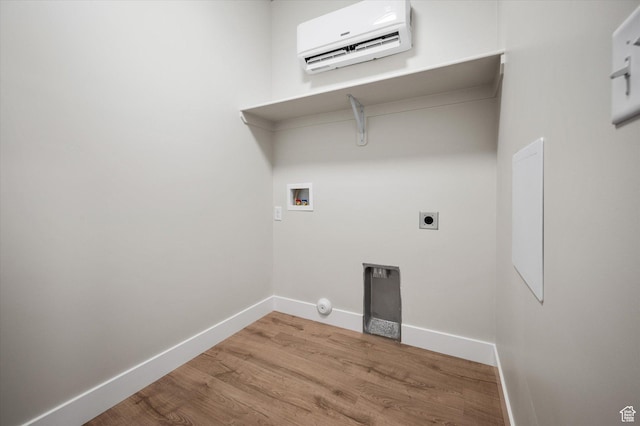 laundry area with a wall mounted air conditioner, hookup for a washing machine, baseboards, wood finished floors, and electric dryer hookup