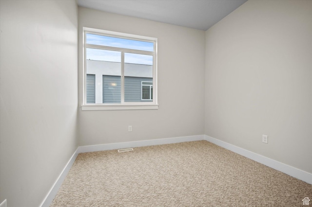 spare room with carpet flooring and baseboards