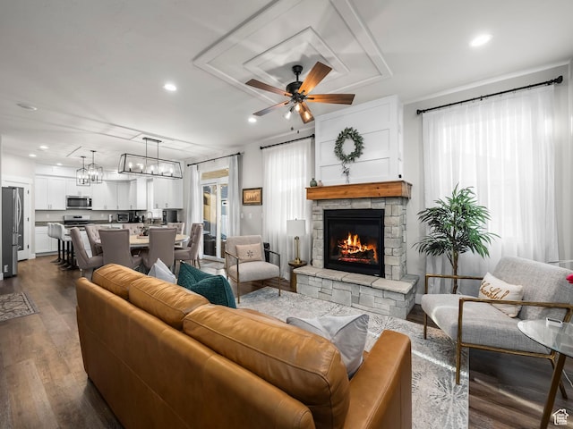 living area with plenty of natural light, a fireplace, dark wood-style flooring, a ceiling fan, and recessed lighting