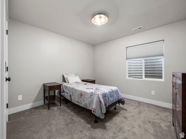 bedroom with baseboards and carpet