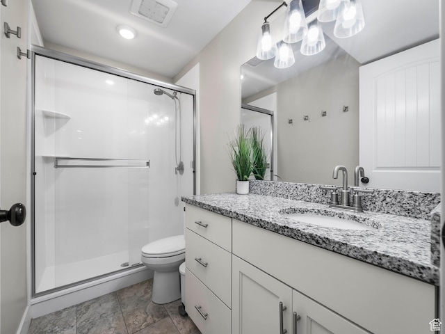 full bath with a shower stall, toilet, and vanity