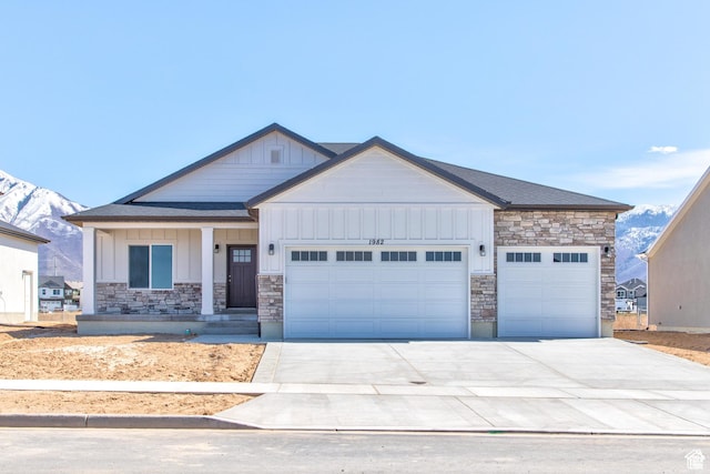 2351 E 370 N Unit 06, Spanish Fork, UT 84660 - view of front of home with stone siding, an attached garage, board and batten siding, and driveway