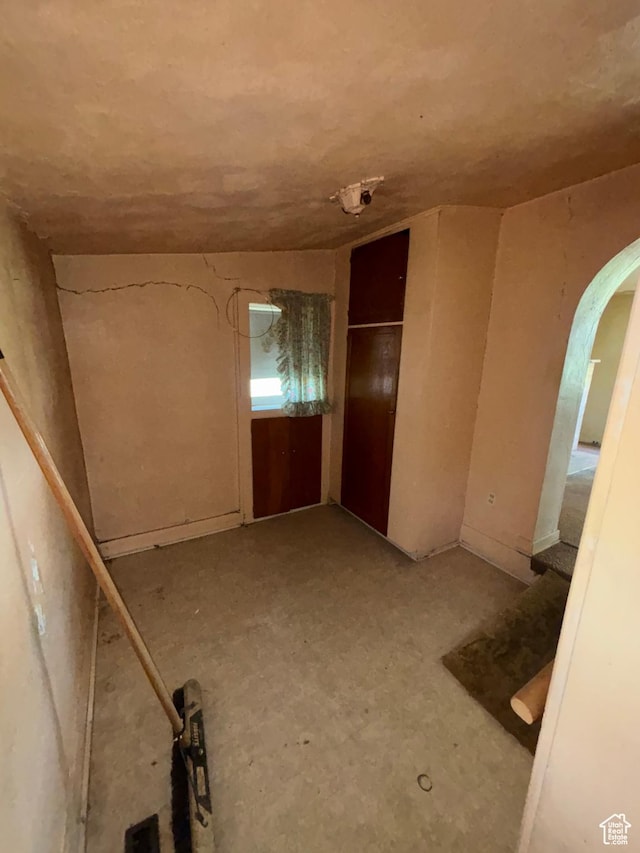 unfurnished room with arched walkways