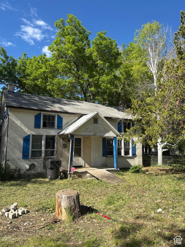 view of front of house with a front lawn and a chimney