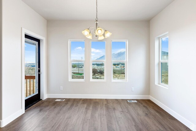 2363 E 370 N Unit 07, Spanish Fork, UT 84660 - unfurnished dining area featuring a chandelier, dark wood-style floors, and baseboards
