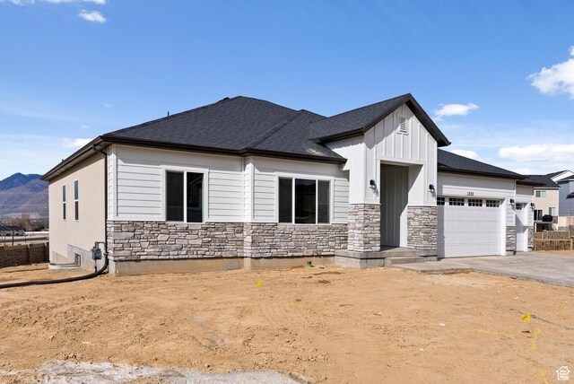 2363 E 370 N Unit 07, Spanish Fork, UT 84660 - view of front facade featuring an attached garage, stone siding, roof with shingles, board and batten siding, and driveway
